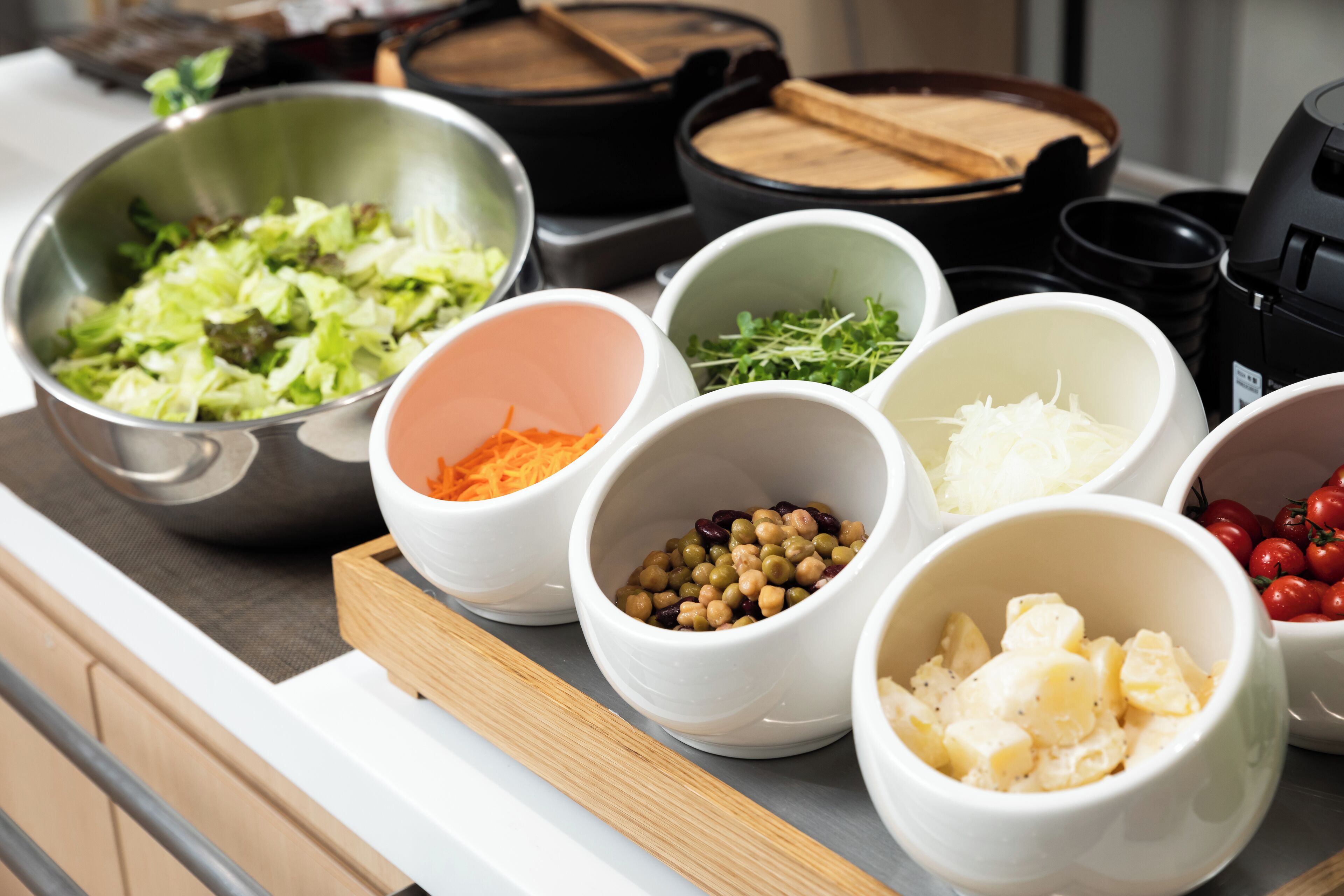A kitchen counter with various bowls containing different ingredients.