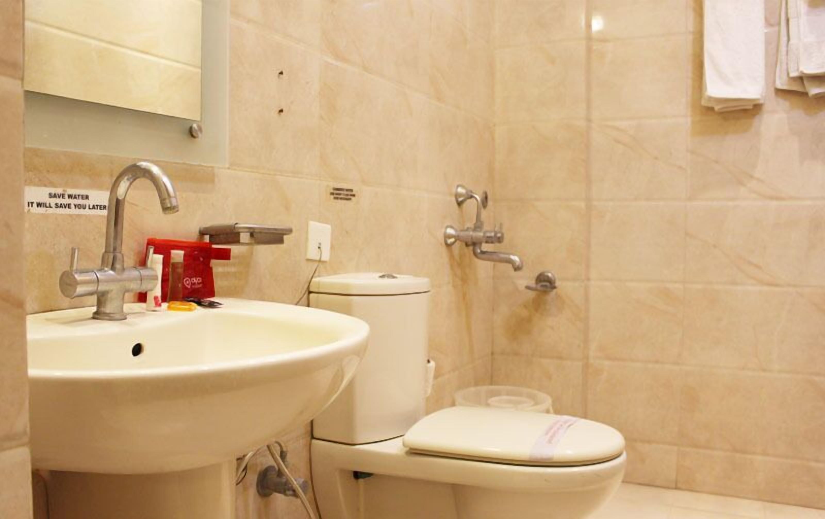 A bathroom with a sink, toilet, and shower.