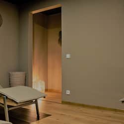Relax in a serene space with two comfortable chairs and decorative wall art.