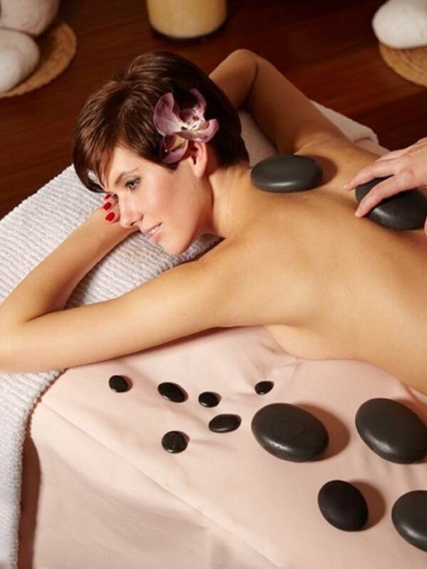 Experience a rejuvenating massage on a comfortable table, surrounded by soothing stones and tranquil ambiance.