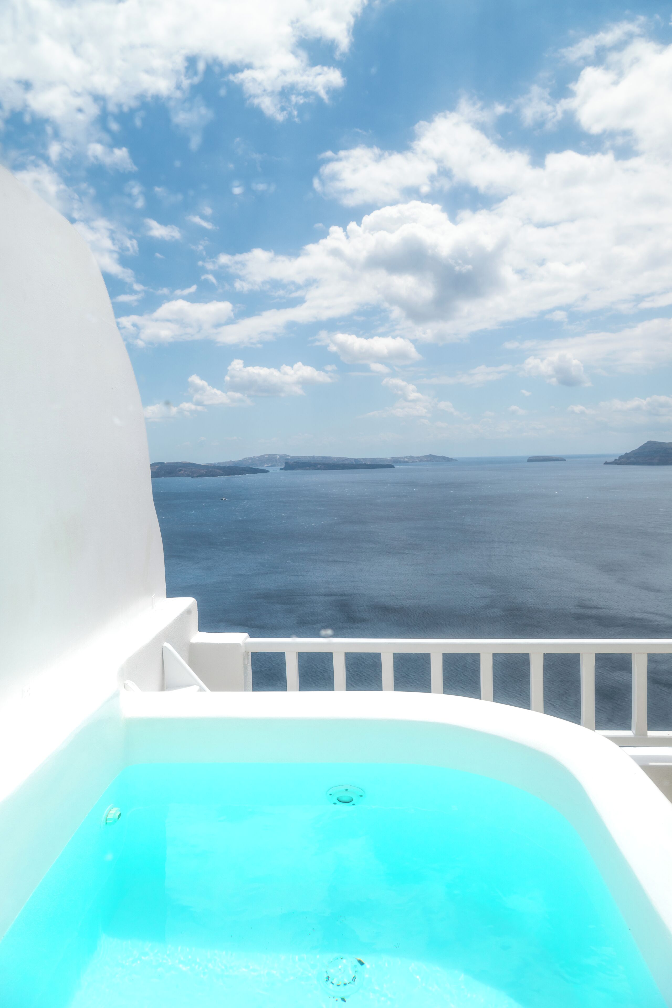 A hot tub with a view of the sea and islands.
