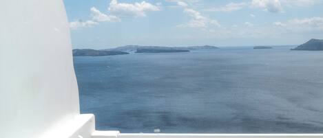 A hot tub with a view of the sea and islands.