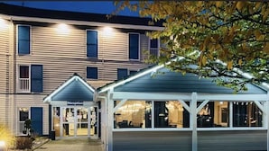 A hotel with a reception area and a covered outdoor seating area.