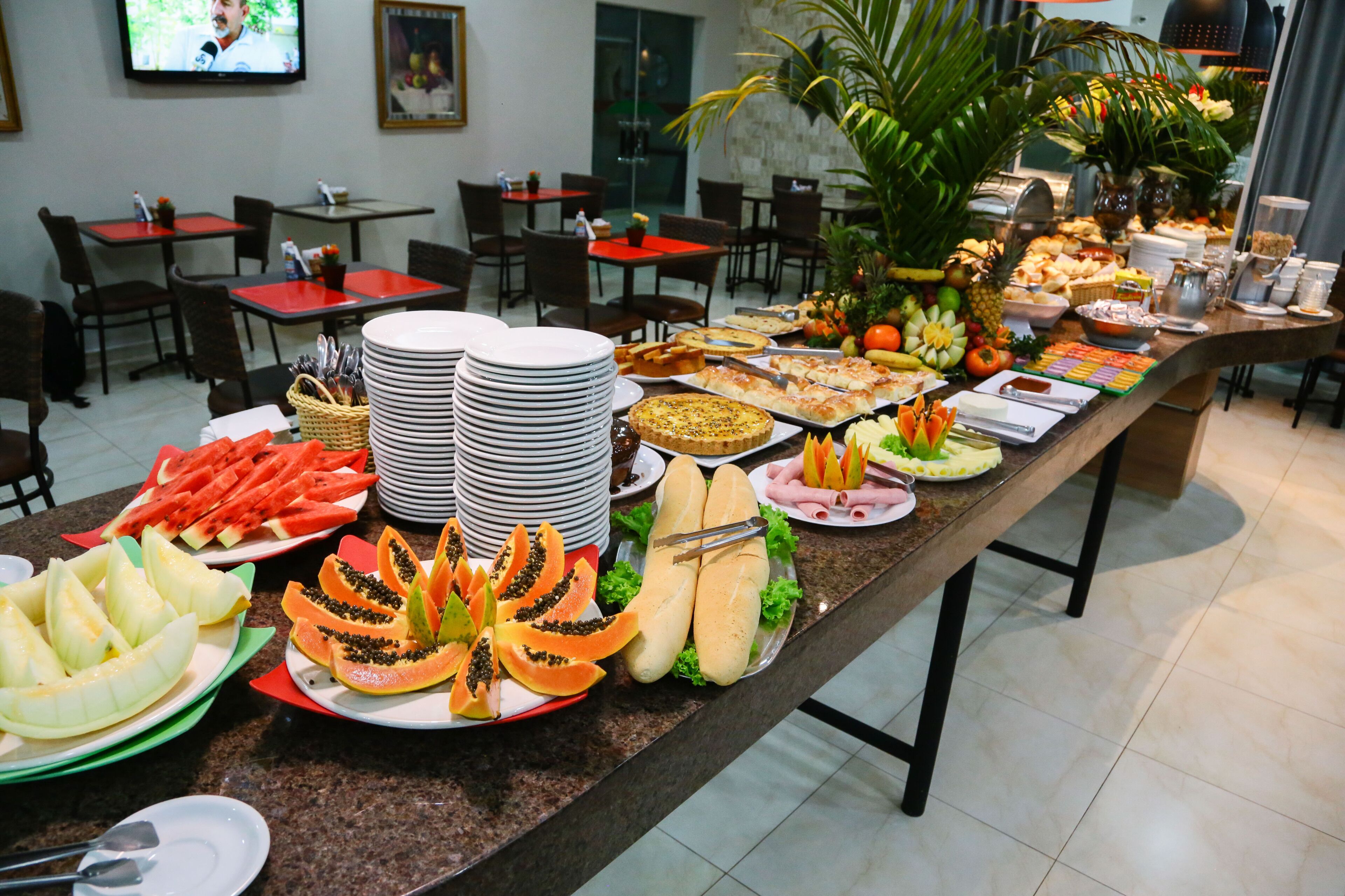 Uma mesa de buffet com diversos alimentos e utensílios.