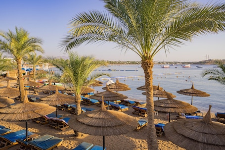 Private beach, sun-loungers, beach umbrellas, beach towels. Marina Sharm Hotel