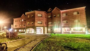 Um hotel com vários andares, fachada de tijolo e várias janelas.