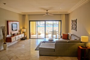 The Deluxe One-Bedroom Residence, All-Inclusive | Living room | 32-inch LCD TV with satellite channels, TV, DVD player - TAN Resorts Marina Cap Cana - All-Inclusive (Punta Cana)