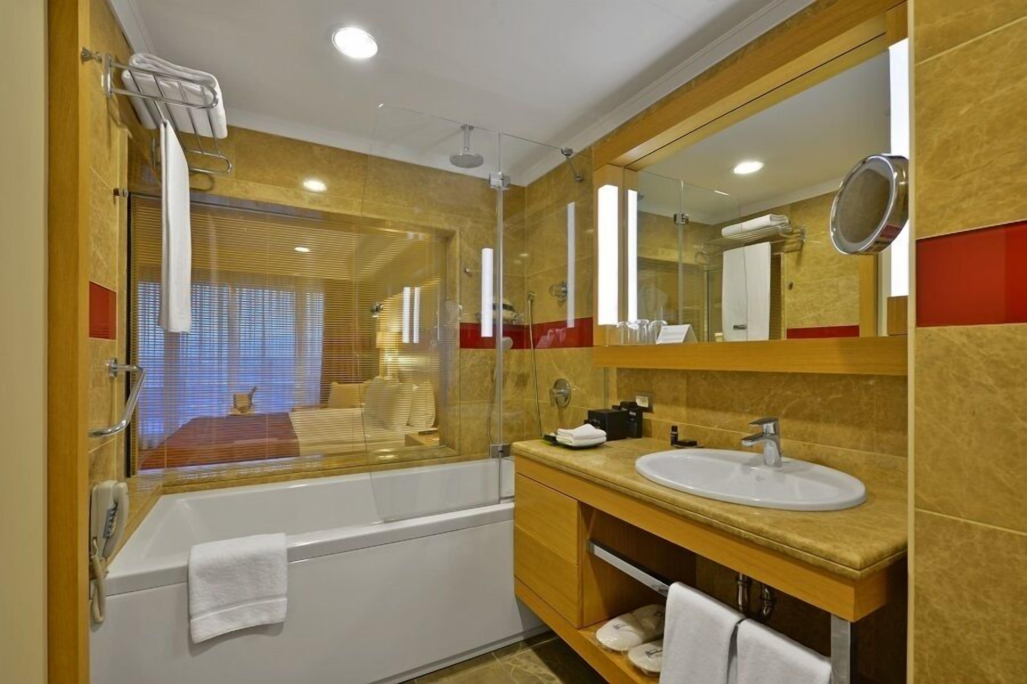 grand deluxe room with garden view | bathroom | rainfall showerhead, eco-friendly toiletries, hair dryer, dressing gowns