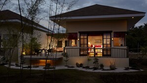 A modern house with a balcony, a dining area, and a well-lit interior. - Bluewater Panglao Beach Resort (Panglao)