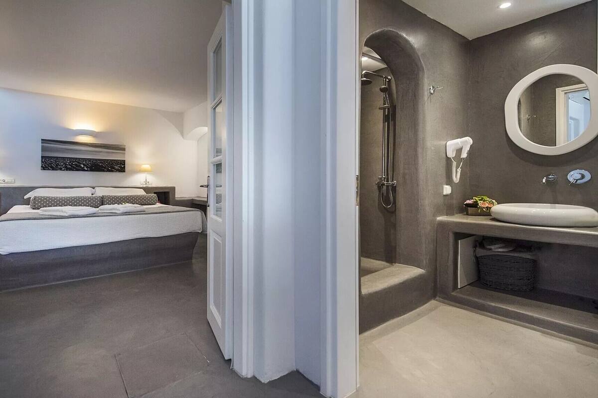 A modern bedroom with a large bed, bedside tables, and a nightstand.