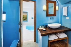 Enjoy a refreshing bathroom retreat with a large sink, mirror, and access to a pool.