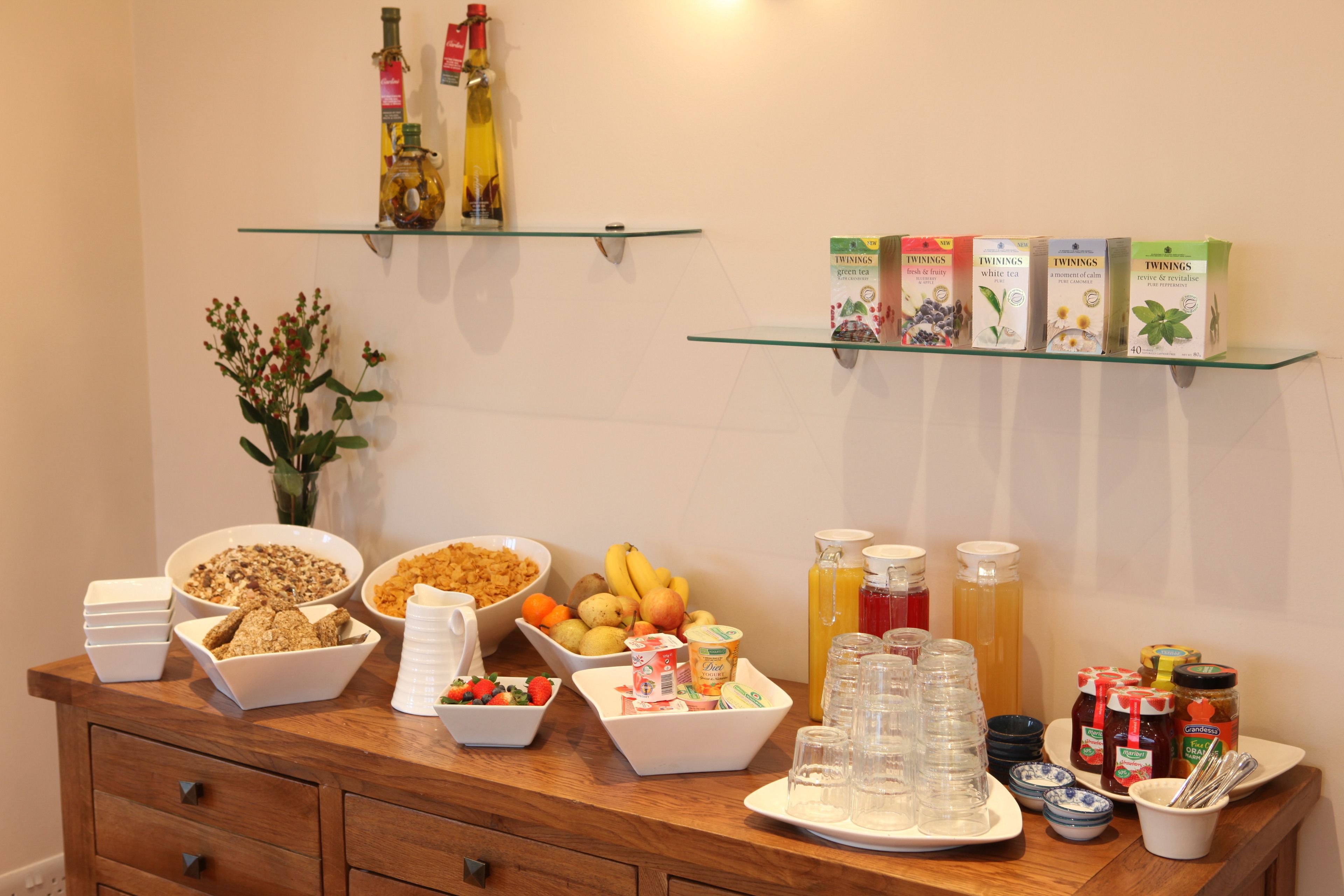 A breakfast buffet with various food items and beverages.