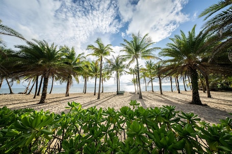 On the beach, sun loungers, beach umbrellas, beach towels. WorldHotels Long Beach Resort Phu Quoc