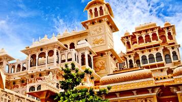 A traditional building with ornate architecture, multiple balconies, and intricate carvings.