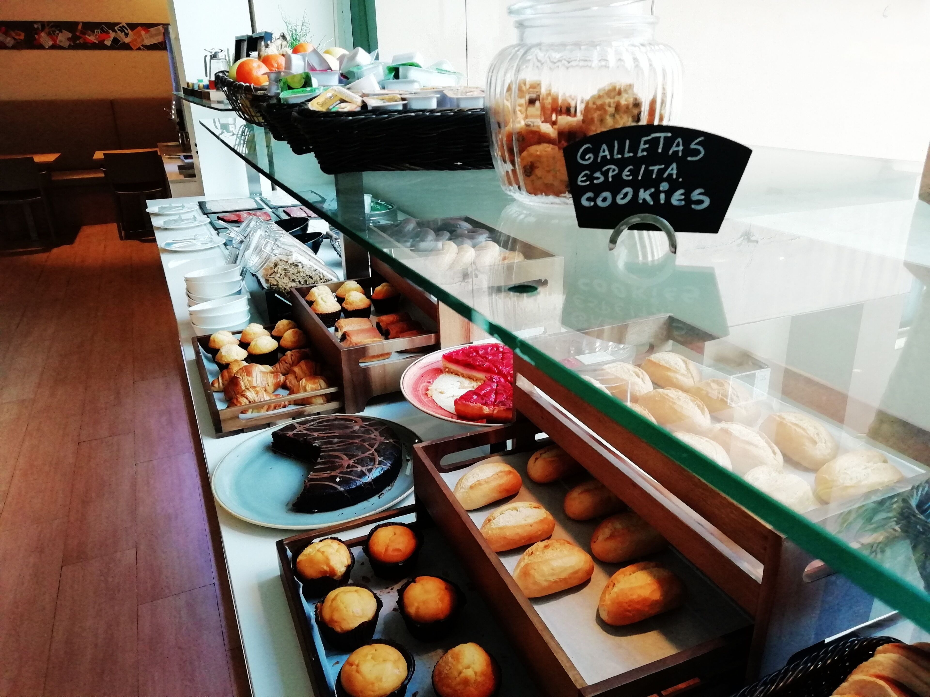 A bakery display with various baked goods like cookies, pastries, and bread.