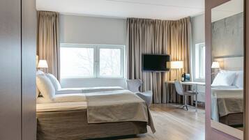 Desk, laptop workspace, iron/ironing board, bed sheets