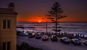 A sunset view with a parking lot and a building.