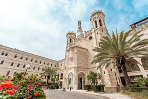 A historic building with a prominent tower and arched windows. - Notre Dame of Jerusalem Center (Jerusalem)