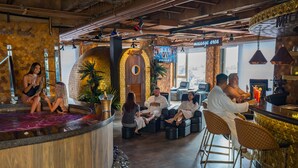 A bar area with seating, a reception desk, and a massage area.