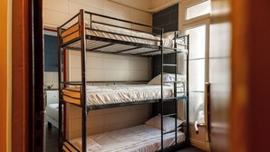 A bunk bed room with a door and a window. - Simple Stay - Fresh Start May 2026 (Nice)