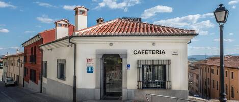 A building with a sign reading "CAFETERIA" and "HOTEL" above it.