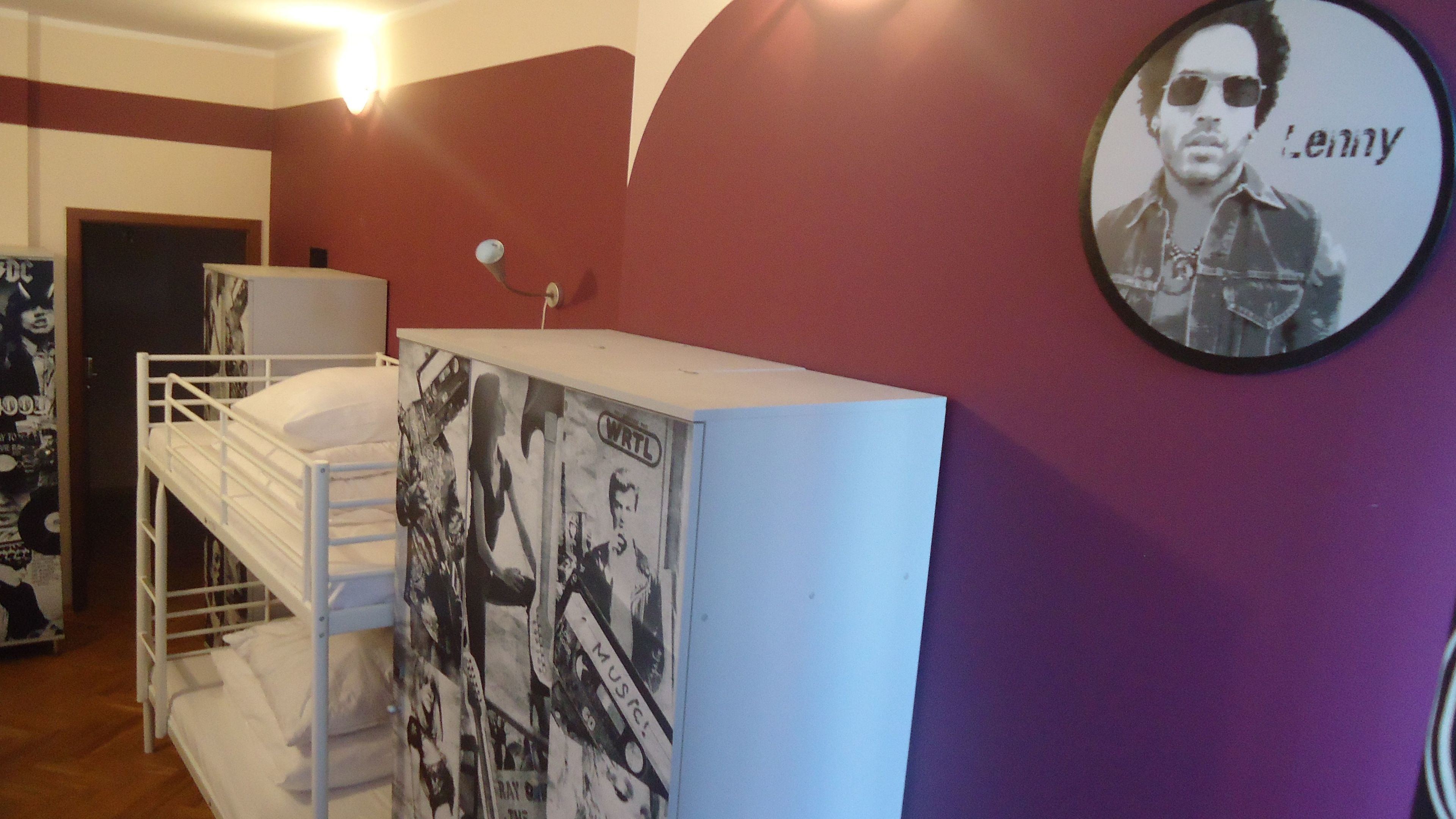 A room with bunk beds, a poster on the wall, and a framed picture.