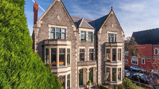 A historic stone building with multiple windows and a prominent chimney. - Lincoln House Hotel (Cardiff)