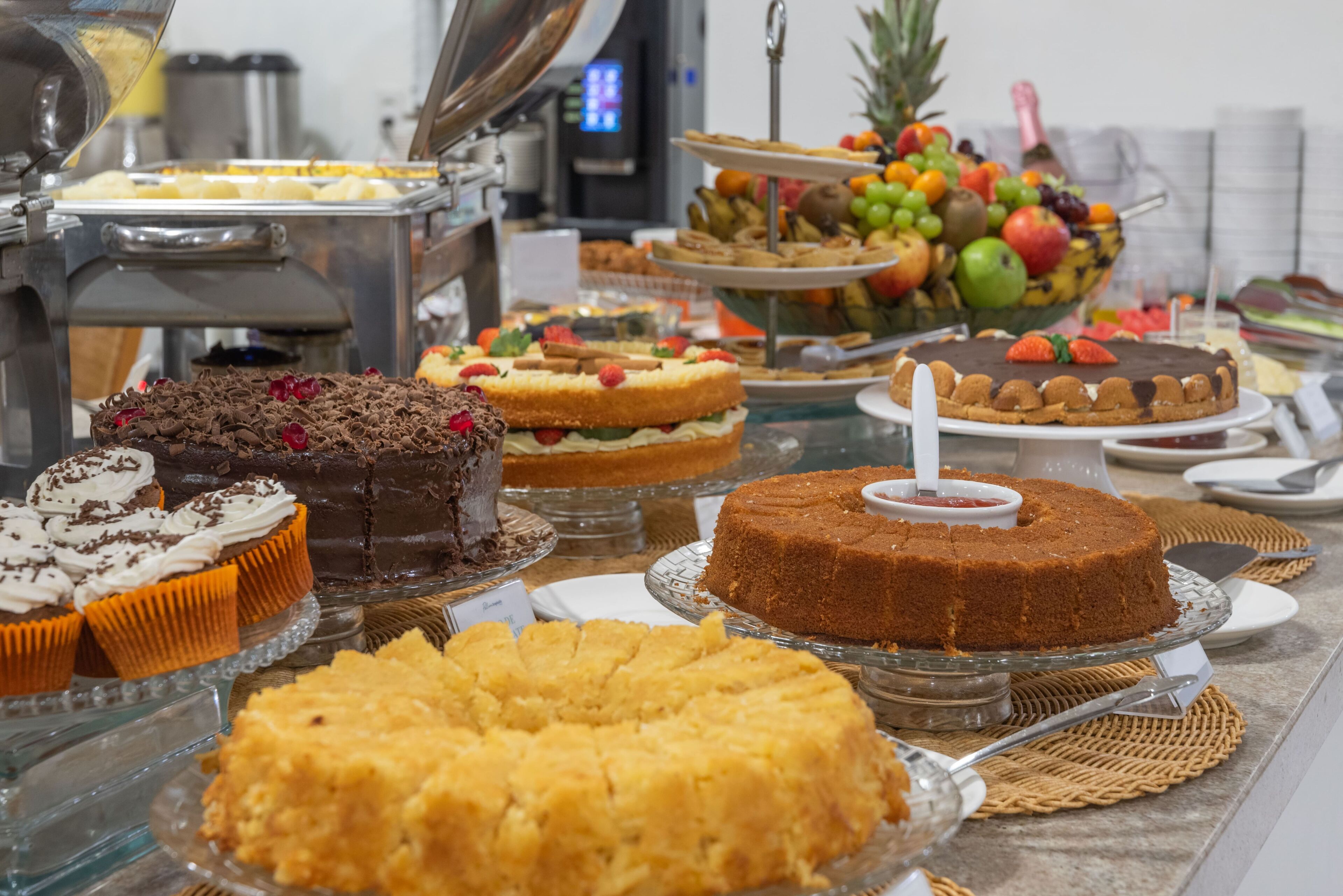 A buffet with various desserts and fruits.
