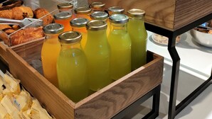 A breakfast buffet with various food items and beverages.