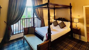 A four-poster bed with a canopy, a ceiling fan, and a window with curtains. - The Peak Hotel (Hope Valley)