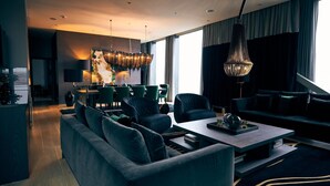 A modern living room with a sofa, coffee table, and dining area. - Clarion Hotel Post, Gothenburg (Gothenburg)