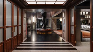 A hotel lobby with a central sculpture, a staircase, and a reception area. - Clarion Hotel Post, Gothenburg (Gothenburg)