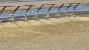 A beach view with a metal railing in the foreground. - Waters Edge (Blackpool)