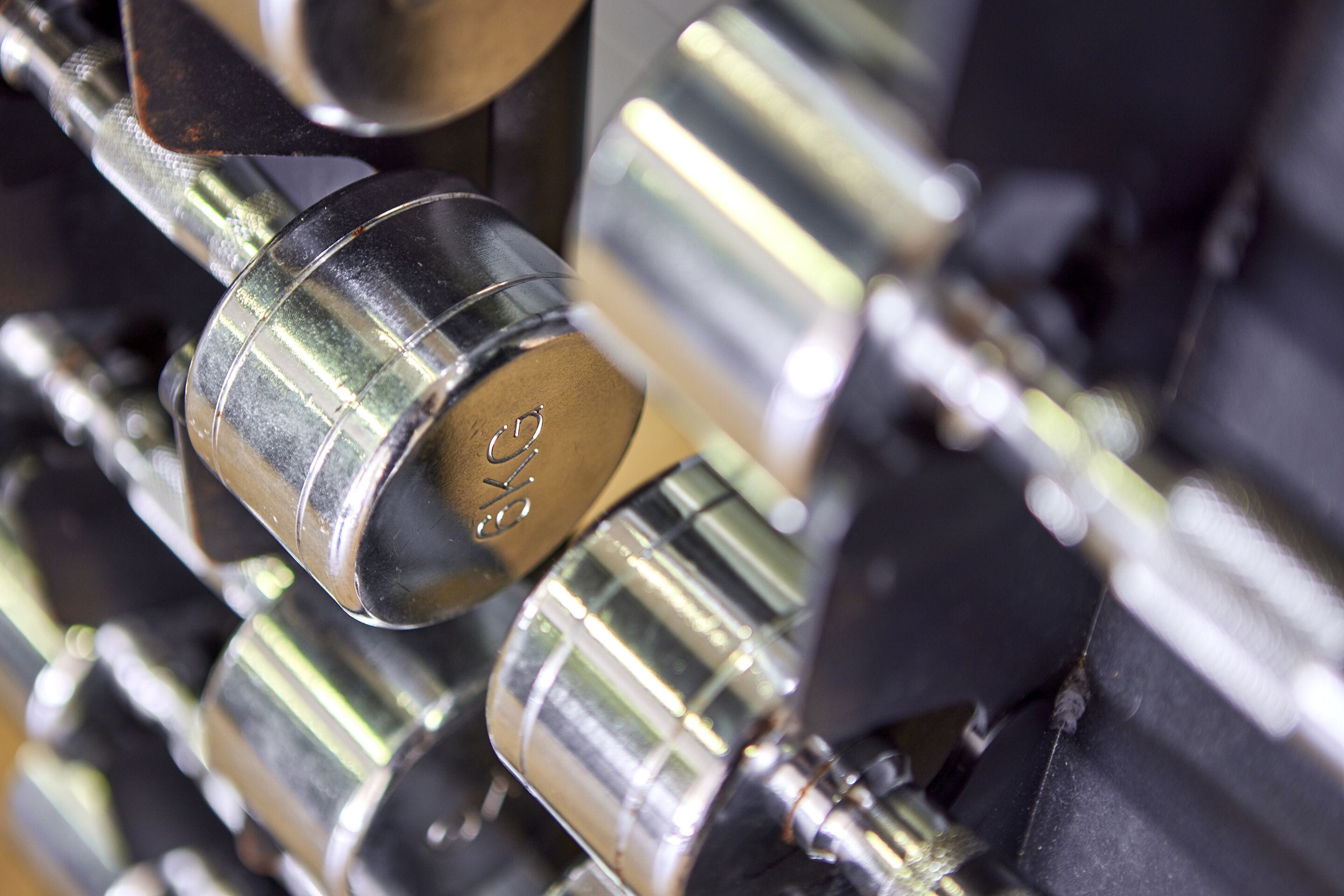 A close-up of metallic objects with engraved text, likely part of a mechanical or industrial setting.