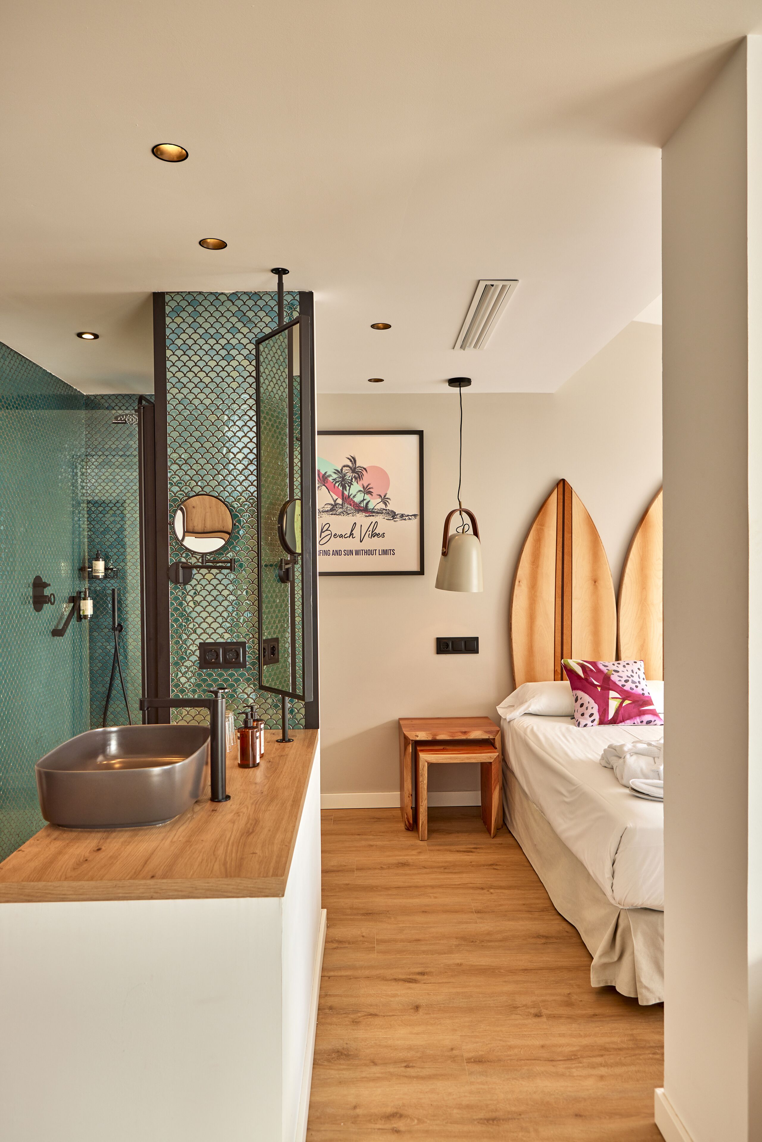 A modern bathroom with a large sink, mirror, and shower.