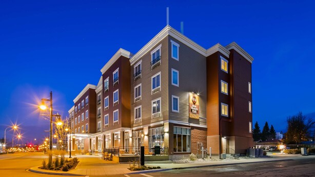 A multi-story hotel with a modern design, featuring a prominent entrance with a covered patio area. - Best Western Plus Chateau Inn Sylvan Lake (Sylvan Lake)