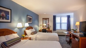 A hotel room with two beds, a desk, a chair, a TV, and a window with curtains. - Federal City Inn & Suites (New Orleans)