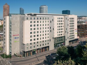 A multi-story hotel with a modern design, featuring a prominent Mercure logo, and surrounded by other high-rise buildings. - Hôtel Mercure Lyon Centre - Gare Part Dieu (Lyon)
