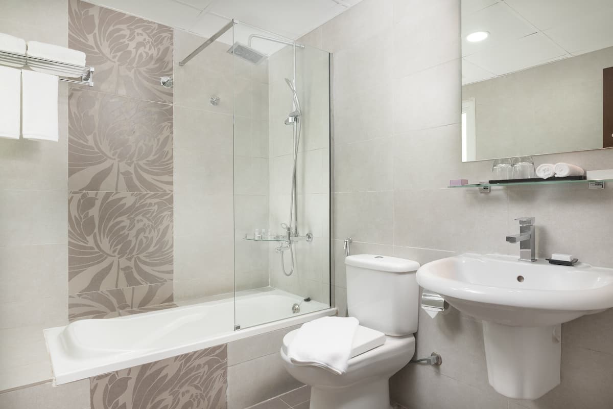 deluxe suite, 1 king bed | bathroom | shower, hair dryer, towels