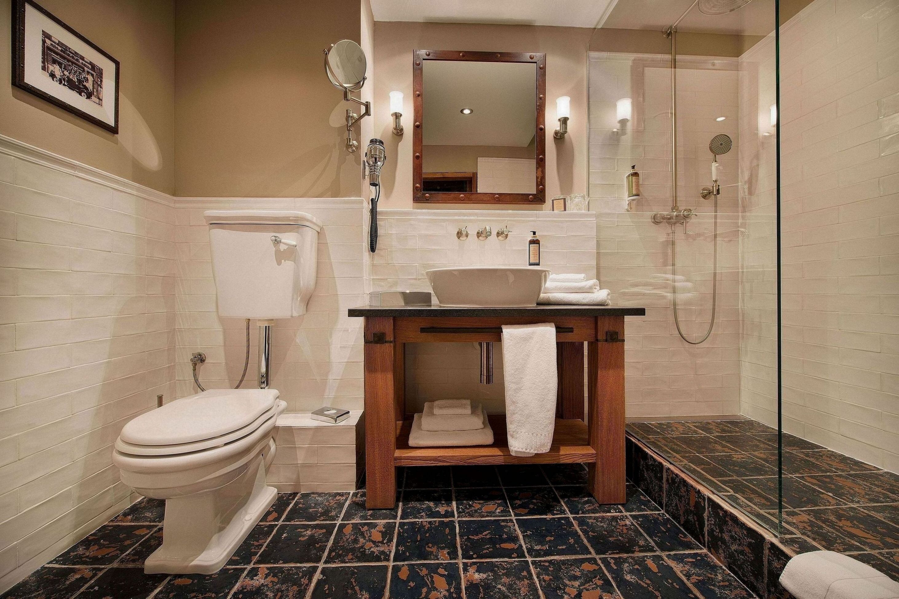 A bathroom with a toilet, sink, and shower.