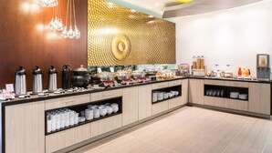 A buffet setup with various food items and serving utensils. - Best Western Plus 93 Park Hotel (Bogotá)
