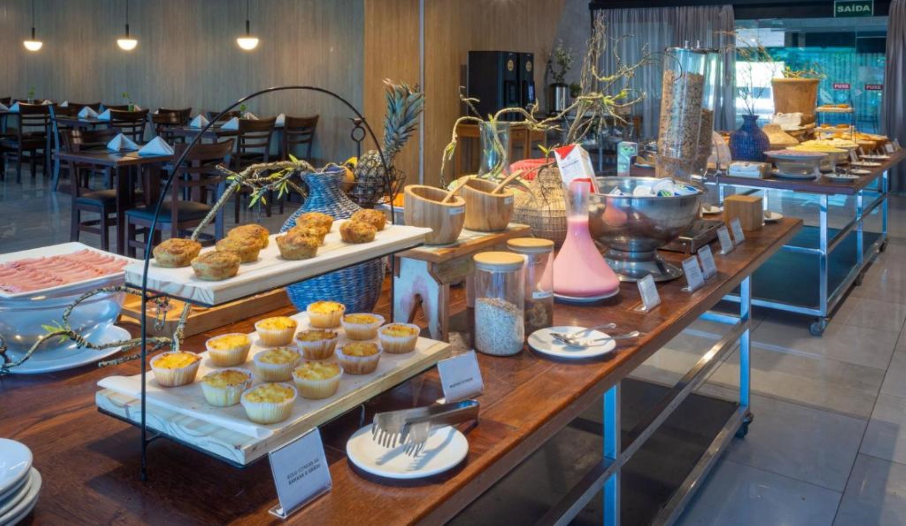 A buffet setup with various food items and utensils.