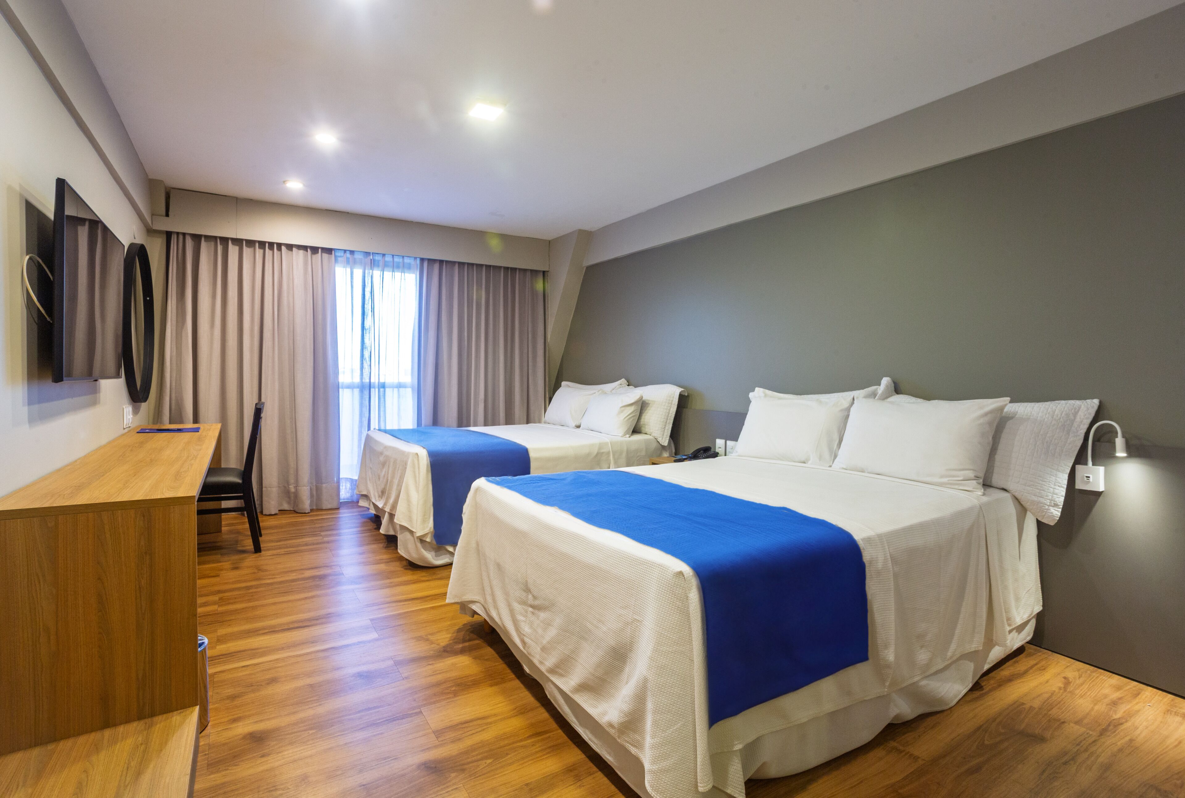 Deluxe Quadruple Room | Minibar, in-room safe, desk, soundproofing