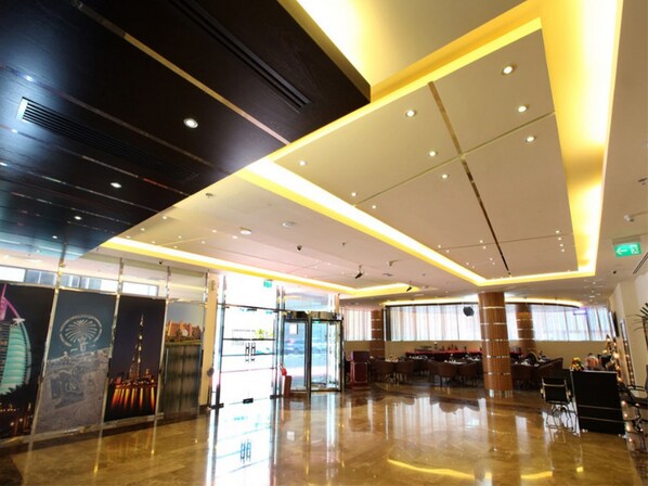 A spacious lobby with a polished floor, a reception desk, and a seating area. - Xclusive Maples Hotel Apartment (Dubai)