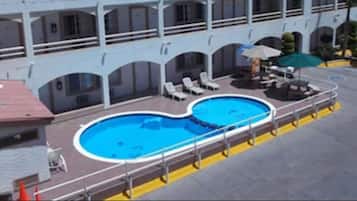 Outdoor pool, open 8 AM to 8 PM, pool umbrellas