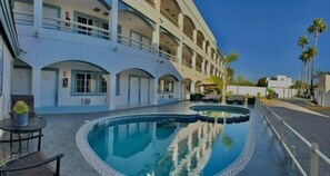 Relax by the circular pool surrounded by a deck and lounge chairs.