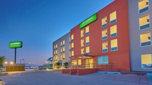 A modern hotel building with a prominent sign for 'City Express' and a large glass entrance. - City Express Junior by Marriott Guadalajara Periférico Sur (Tlaquepaque)