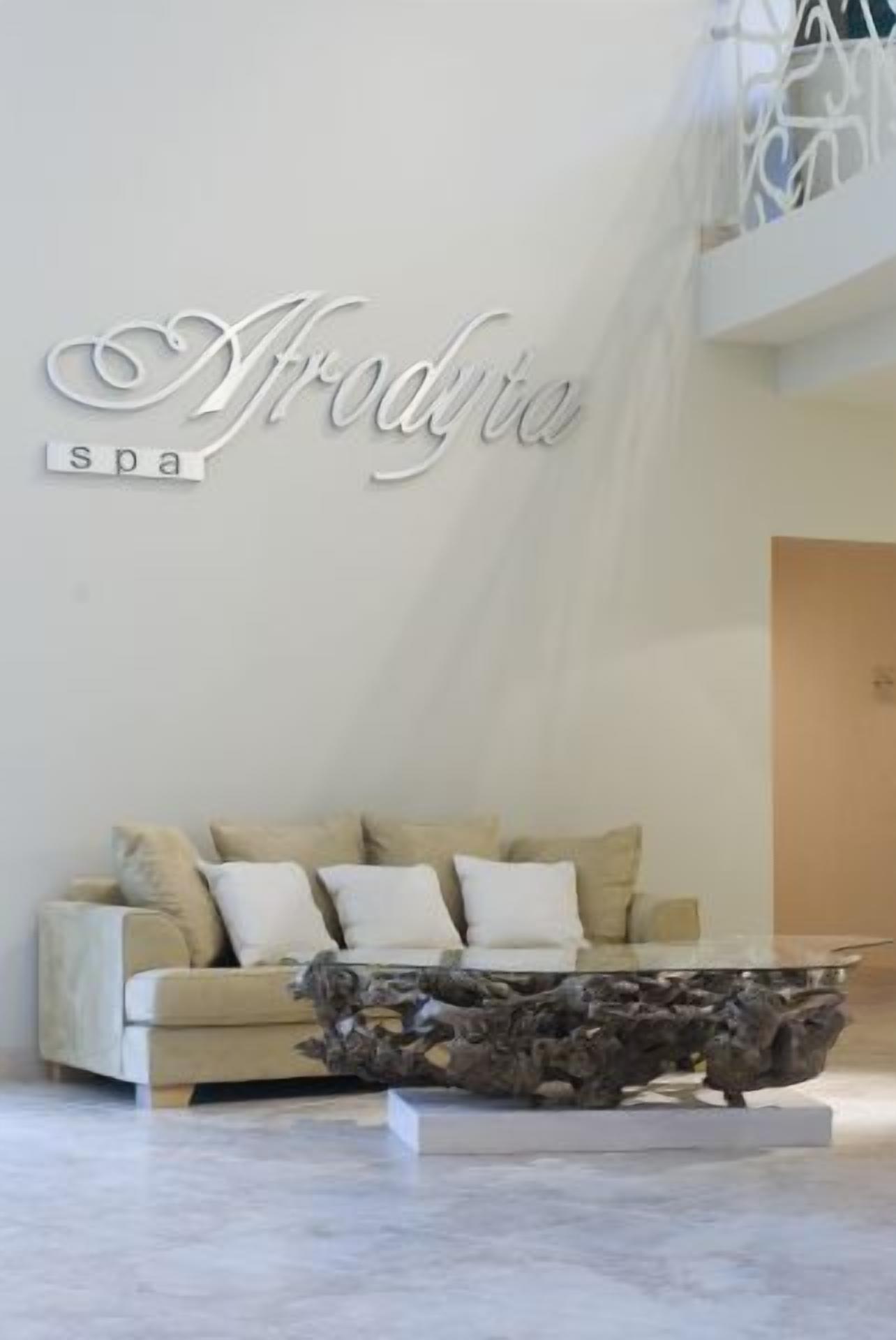 A modern interior with a sofa, decorative wall art, and a unique coffee table.