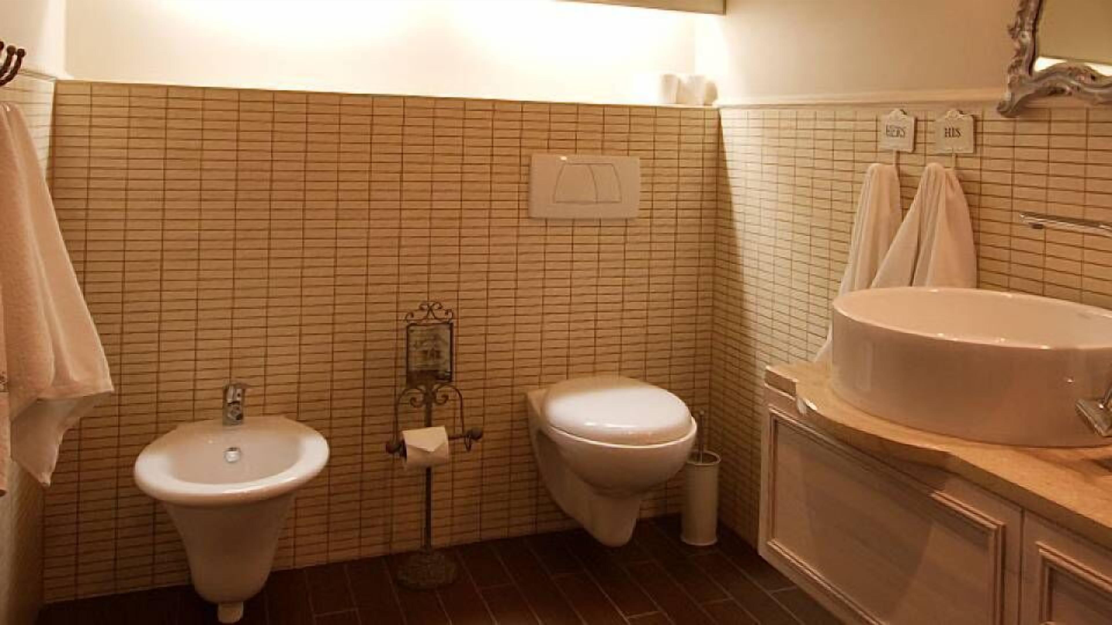 Een badkamer met een wastafel, toilet en bad.