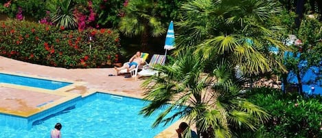 Seasonal outdoor pool, open 10:00 AM to 5:00 PM, pool umbrellas